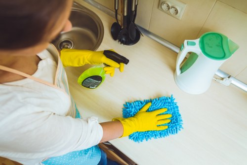 Kitchen cleaning in a London flat with surfaces, sink, and worktops being refreshed