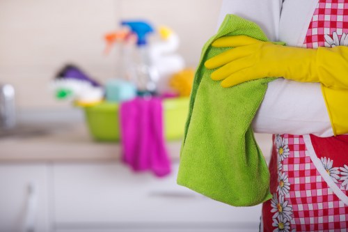 Local London house cleaning team working in a residential property with stairs and hallway